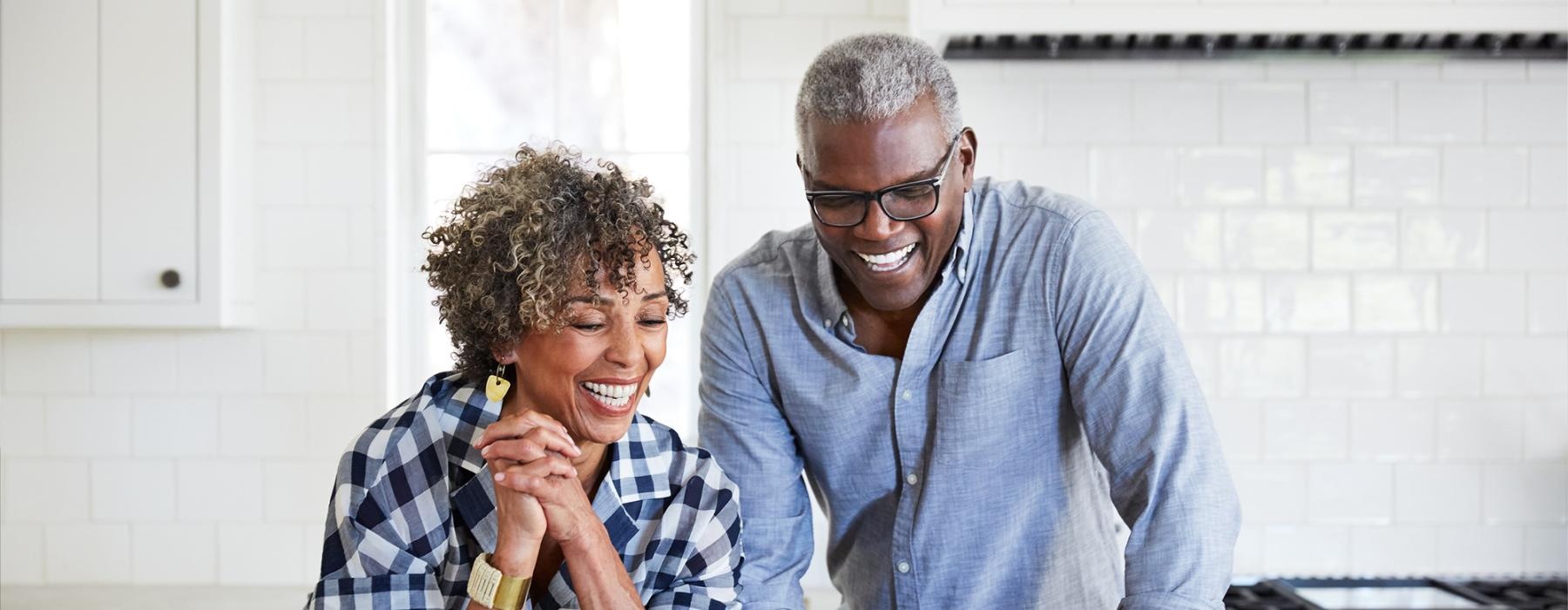 a man and a woman looking at a laptop