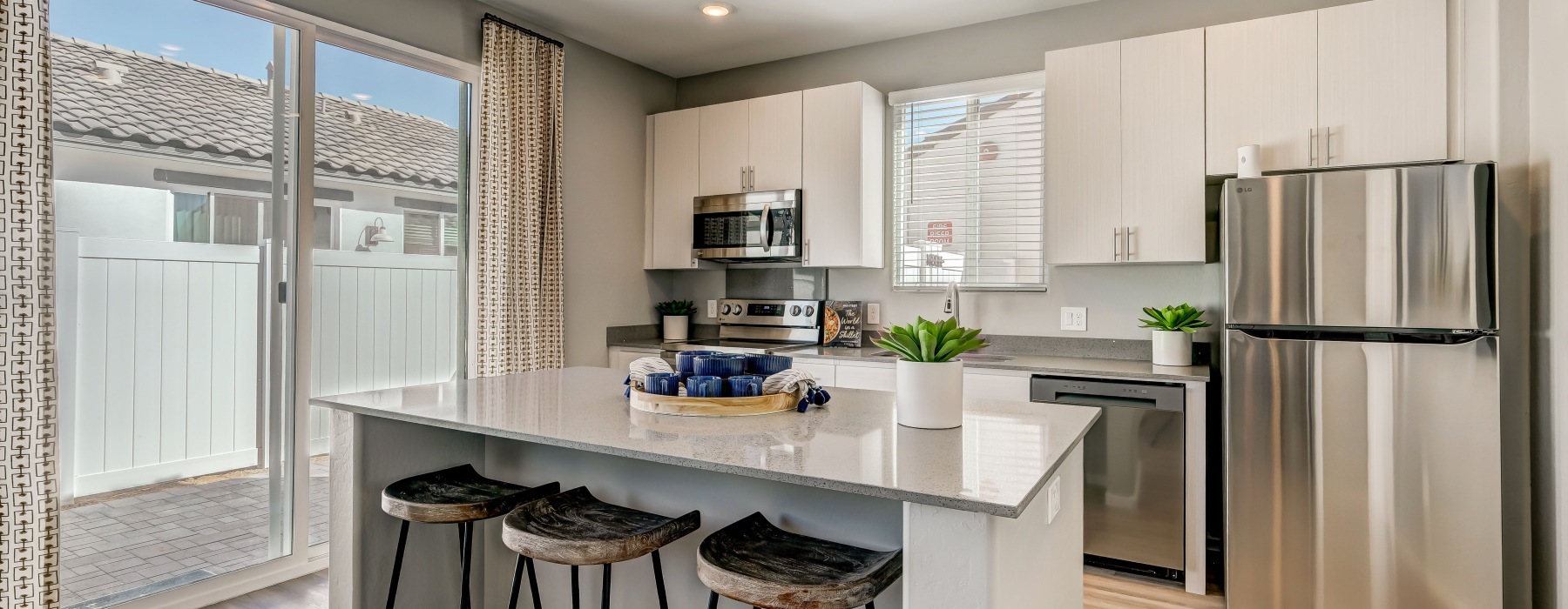 B2 floor plan, white cabinetry with stainless steel appliances and quartz countertops
