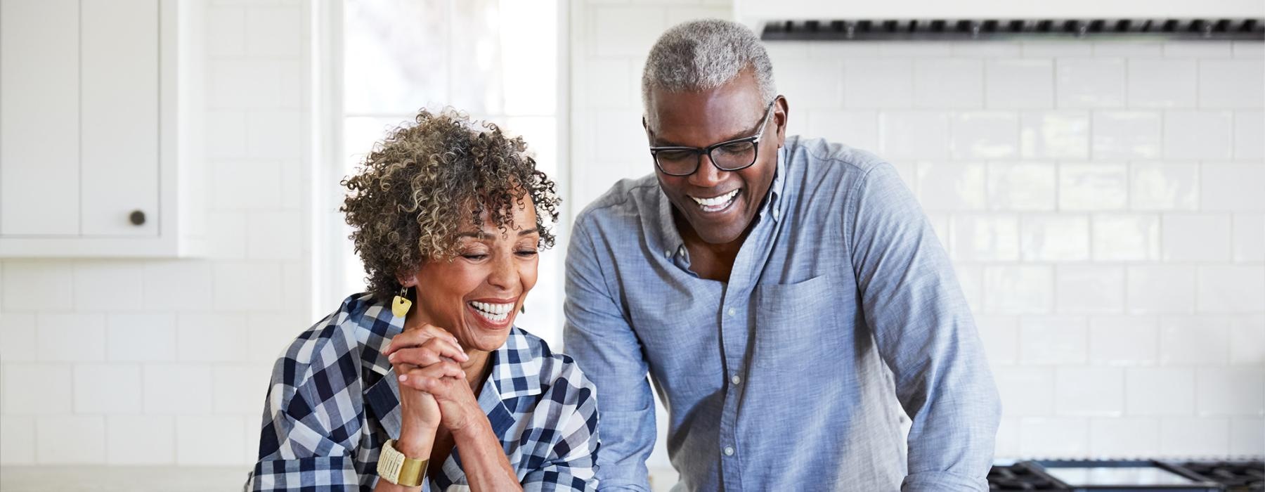 a man and a woman looking at a laptop